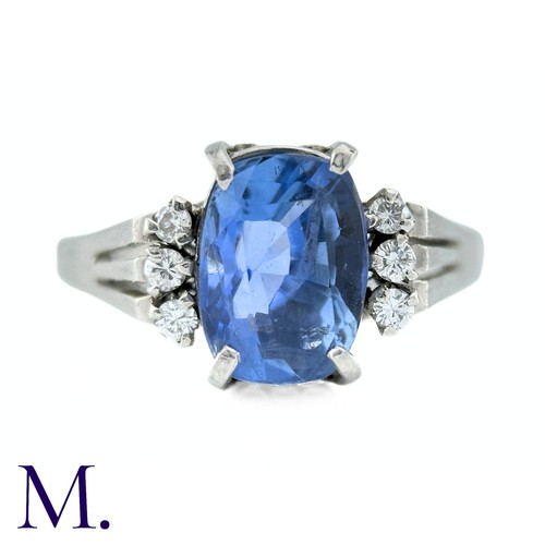 78 - A Ceylon No Heat Sapphire And Diamond Ring in platinum, the principal cushion cut Sapphire of approx... 