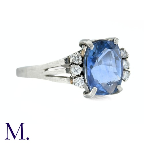 78 - A Ceylon No Heat Sapphire And Diamond Ring in platinum, the principal cushion cut Sapphire of approx... 