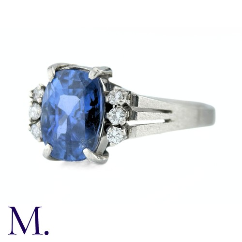 78 - A Ceylon No Heat Sapphire And Diamond Ring in platinum, the principal cushion cut Sapphire of approx... 