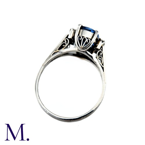 78 - A Ceylon No Heat Sapphire And Diamond Ring in platinum, the principal cushion cut Sapphire of approx... 