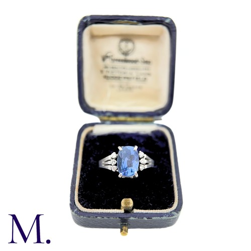 78 - A Ceylon No Heat Sapphire And Diamond Ring in platinum, the principal cushion cut Sapphire of approx... 