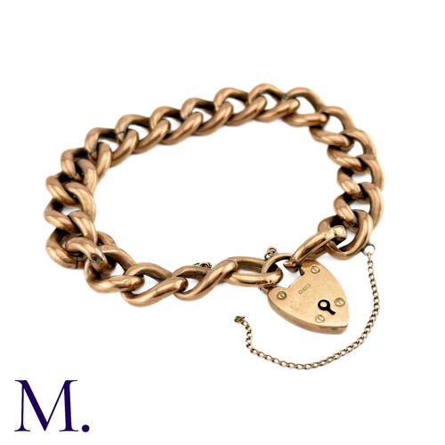 1 - An Antique Curb Bracelet in 9k rose gold, comprising a series of polished curb links, suspending a h... 