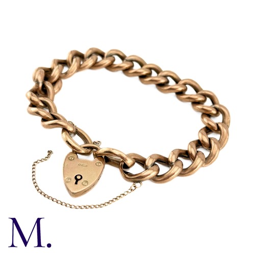 1 - An Antique Curb Bracelet in 9k rose gold, comprising a series of polished curb links, suspending a h... 