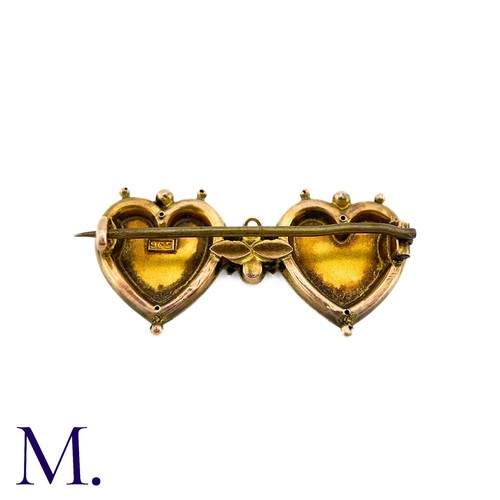 19 - An Antique Mizpah Brooch in 9k gold, designed as two hearts embossed with the word 'mizpah' and engr... 