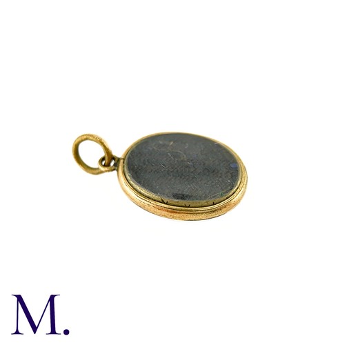 50 - An Antique Mourning Locket Pendant in yellow gold, the oval form with engraved scrolling detail to t... 