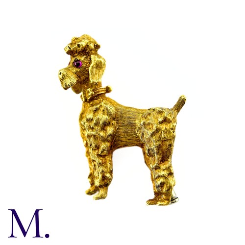 284 - A Poodle Brooch in 18k yellow gold, with textured design set with cabochon ruby eyes. Stamped 750, I... 