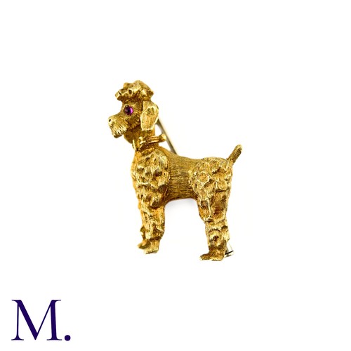 284 - A Poodle Brooch in 18k yellow gold, with textured design set with cabochon ruby eyes. Stamped 750, I... 