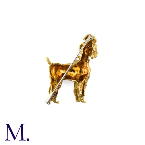 284 - A Poodle Brooch in 18k yellow gold, with textured design set with cabochon ruby eyes. Stamped 750, I... 