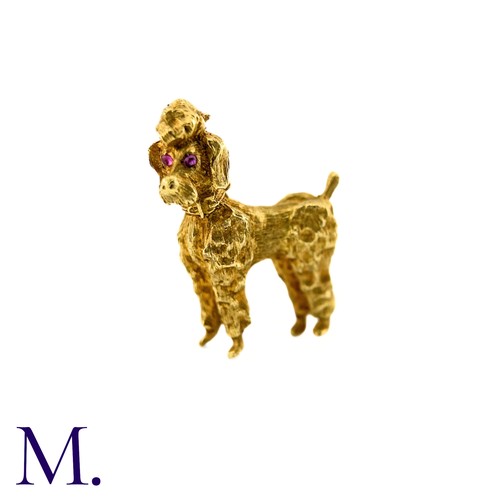 284 - A Poodle Brooch in 18k yellow gold, with textured design set with cabochon ruby eyes. Stamped 750, I... 