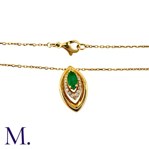 80 - An Emerald And Diamond Pendant in 18k yellow gold, set with a marquise cut emerald and accented by r... 