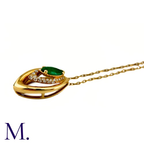 80 - An Emerald And Diamond Pendant in 18k yellow gold, set with a marquise cut emerald and accented by r... 