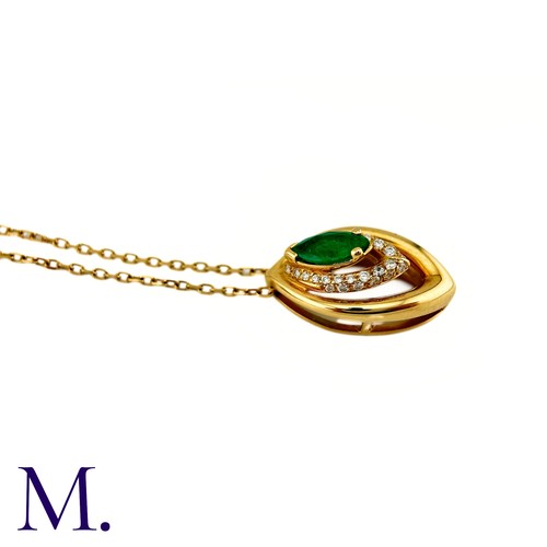 80 - An Emerald And Diamond Pendant in 18k yellow gold, set with a marquise cut emerald and accented by r... 