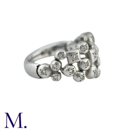 57 - An Articulated Diamond Ring in 18K white gold, of abstract form, the face of the ring with hinged me... 