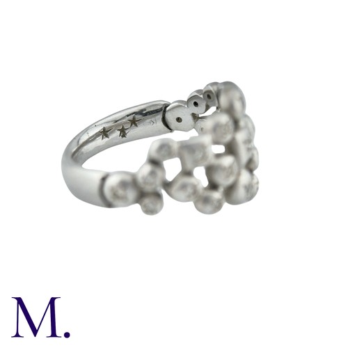 57 - An Articulated Diamond Ring in 18K white gold, of abstract form, the face of the ring with hinged me... 