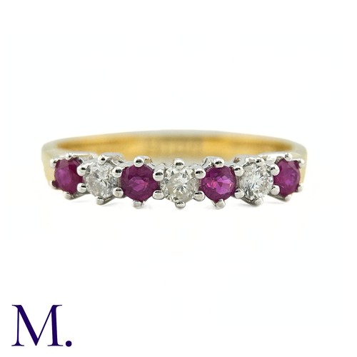 25 - A Ruby And Diamond Seven Stone Ring in 18k yellow gold, set with a row of alternating rubies and dia... 