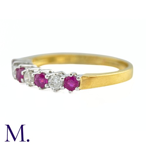 25 - A Ruby And Diamond Seven Stone Ring in 18k yellow gold, set with a row of alternating rubies and dia... 