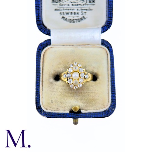 26 - A Pearl And Diamond Ring in yellow gold, the navette form set to the centre with a trio of pearls su... 