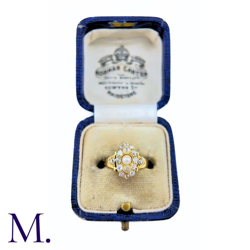 26 - A Pearl And Diamond Ring in yellow gold, the navette form set to the centre with a trio of pearls su... 