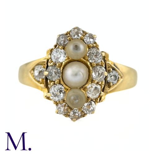 26 - A Pearl And Diamond Ring in yellow gold, the navette form set to the centre with a trio of pearls su... 