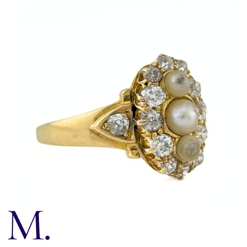 26 - A Pearl And Diamond Ring in yellow gold, the navette form set to the centre with a trio of pearls su... 