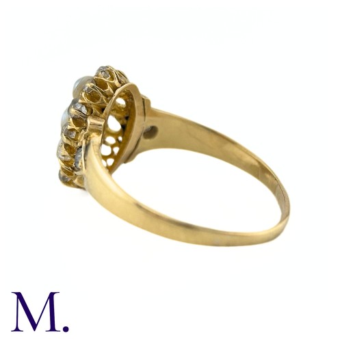 26 - A Pearl And Diamond Ring in yellow gold, the navette form set to the centre with a trio of pearls su... 