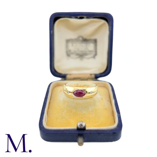 28 - A Ruby And Diamond Gypsy Ring in 18k yellow gold, set to the centre with a cabochon ruby, flanked ea... 