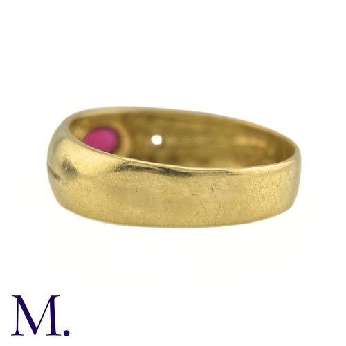 28 - A Ruby And Diamond Gypsy Ring in 18k yellow gold, set to the centre with a cabochon ruby, flanked ea... 