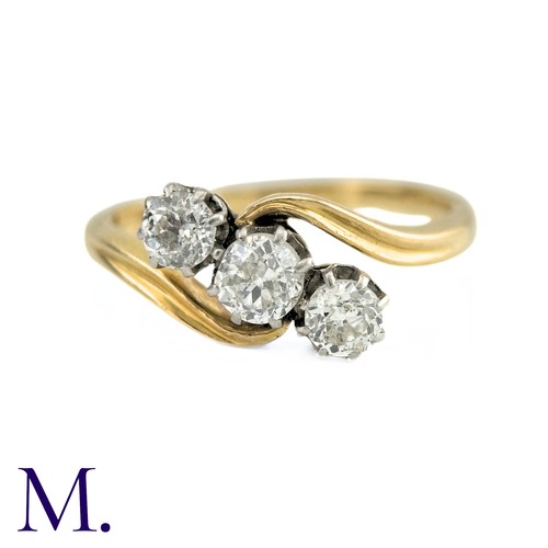 63 - A Diamond Three Stone Twist Ring in 18k gold, Set with three round cut diamonds totalling approximat... 