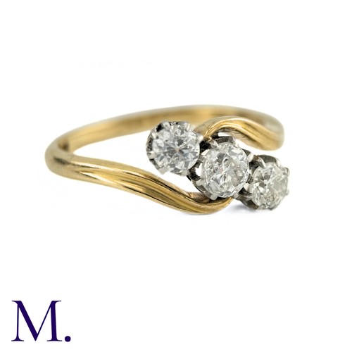 63 - A Diamond Three Stone Twist Ring in 18k gold, Set with three round cut diamonds totalling approximat... 