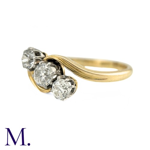 63 - A Diamond Three Stone Twist Ring in 18k gold, Set with three round cut diamonds totalling approximat... 