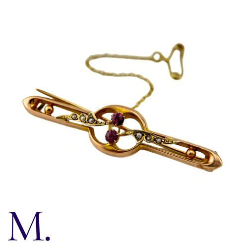 29 - A Ruby And Pearl Brooch in 9k yellow gold, centrally set with two round cut rubies, with pearl set f... 