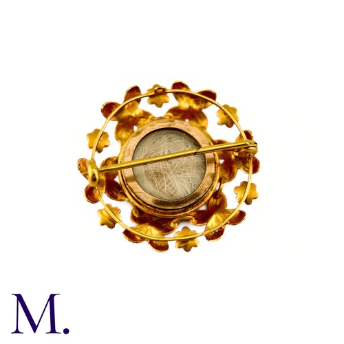 286 - A Sapphire And Pearl Clover Brooch in 9k yellow gold, circular brooch with a clover motif set with c... 