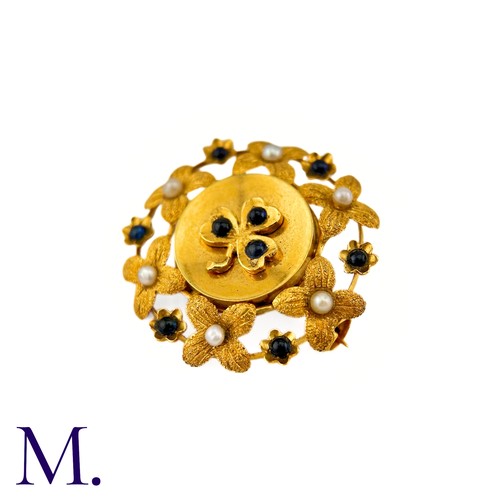 286 - A Sapphire And Pearl Clover Brooch in 9k yellow gold, circular brooch with a clover motif set with c... 