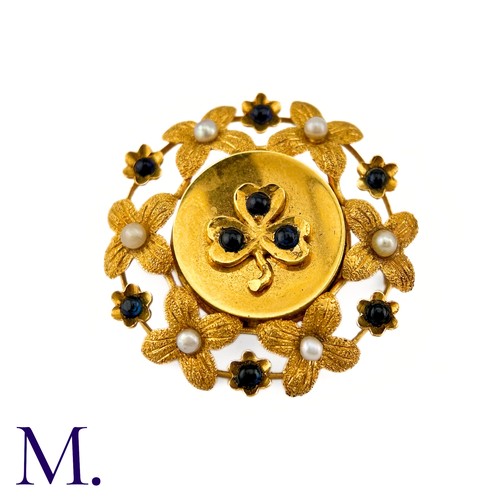 286 - A Sapphire And Pearl Clover Brooch in 9k yellow gold, circular brooch with a clover motif set with c... 