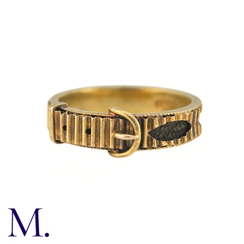 40 - An Antique Hairwork Mourning ring in 15k yellow gold, of belt buckle design the fluted band with nav... 