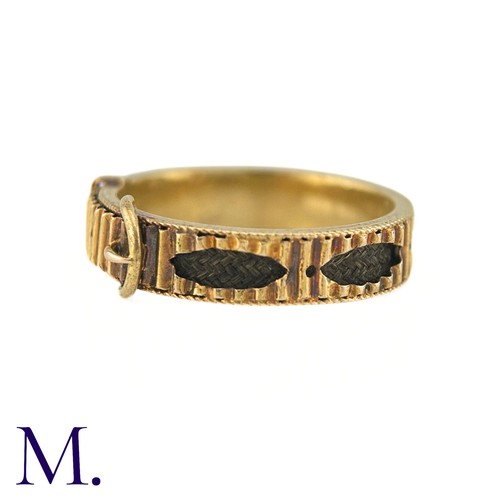 40 - An Antique Hairwork Mourning ring in 15k yellow gold, of belt buckle design the fluted band with nav... 