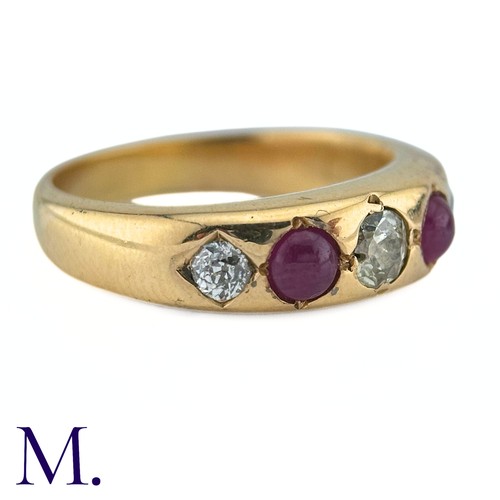 41 - A Ruby And Diamond Gypsy Ring in yellow gold, set with three old cut diamonds punctuated by two cabo... 