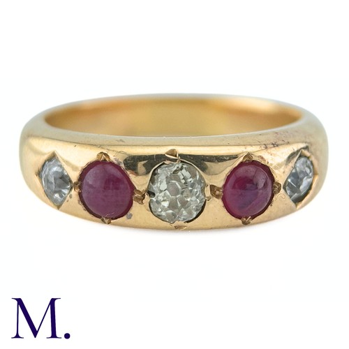 41 - A Ruby And Diamond Gypsy Ring in yellow gold, set with three old cut diamonds punctuated by two cabo... 