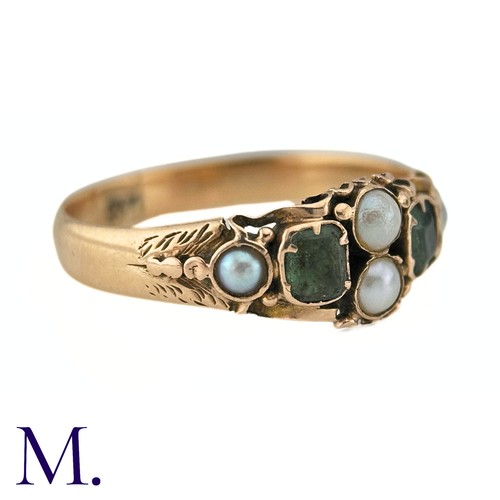 38 - An Antique Emerald And Pearl Ring in 15k yellow gold, set with two step cut emeralds and accented by... 