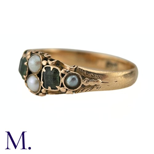 38 - An Antique Emerald And Pearl Ring in 15k yellow gold, set with two step cut emeralds and accented by... 