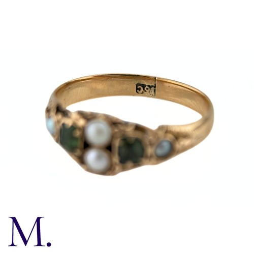 38 - An Antique Emerald And Pearl Ring in 15k yellow gold, set with two step cut emeralds and accented by... 