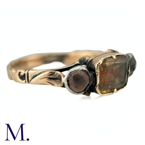 61 - An Antique Chrysoberyl And Goshenite Three Stone Ring in yellow gold, the central chrysoberyl flanke... 