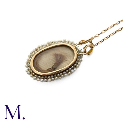 230 - An Antique Enamel and Pearl Pendant with Chain in yellow gold, the front with blue and white enamel,... 