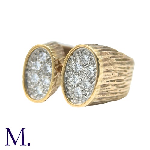 49 - A Diamond Ring in yellow gold, the textured form with two oval plaques set with round cut diamonds. ... 