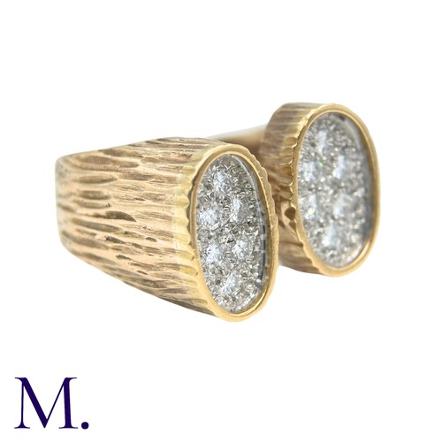 49 - A Diamond Ring in yellow gold, the textured form with two oval plaques set with round cut diamonds. ... 
