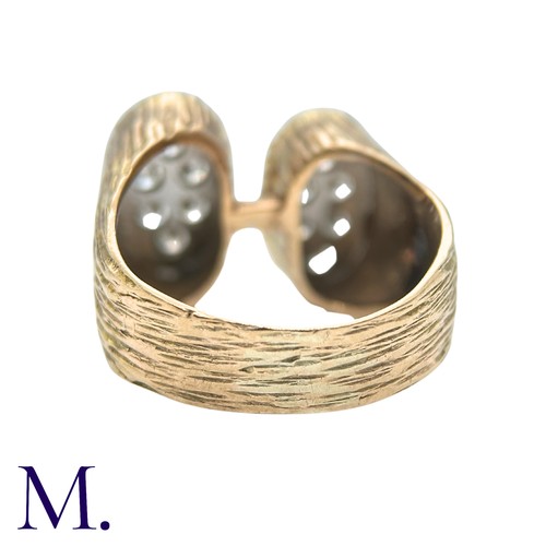 49 - A Diamond Ring in yellow gold, the textured form with two oval plaques set with round cut diamonds. ... 