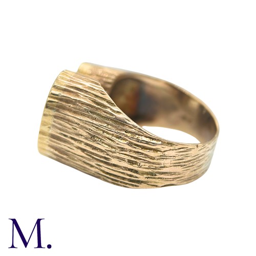 49 - A Diamond Ring in yellow gold, the textured form with two oval plaques set with round cut diamonds. ... 