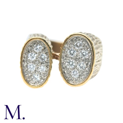 49 - A Diamond Ring in yellow gold, the textured form with two oval plaques set with round cut diamonds. ... 