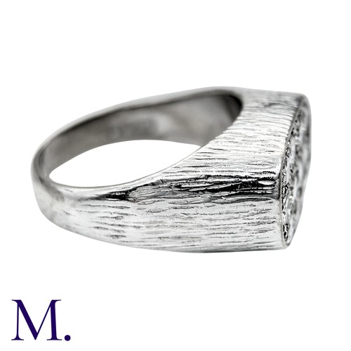 237 - A Diamond Ring in 18k white gold, the textured form set to the oval face with round brilliant cut di... 