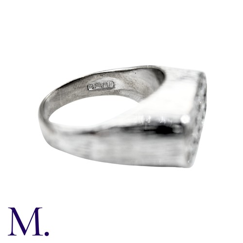 237 - A Diamond Ring in 18k white gold, the textured form set to the oval face with round brilliant cut di... 
